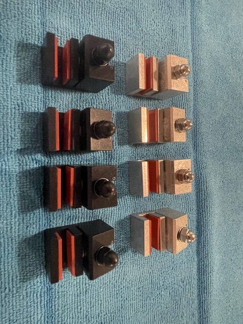 Updated Cobra-Grille aluminum mounting blocks in black and unfinished metal, shown with fasteners